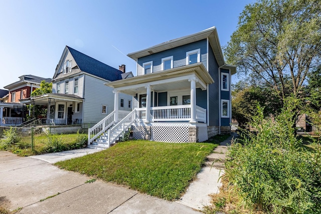 view of front facade with fence private yard and a porch