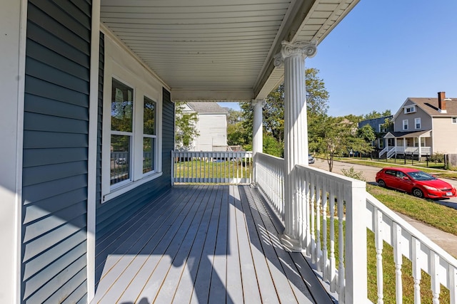 wooden deck featuring a residential view and a porch