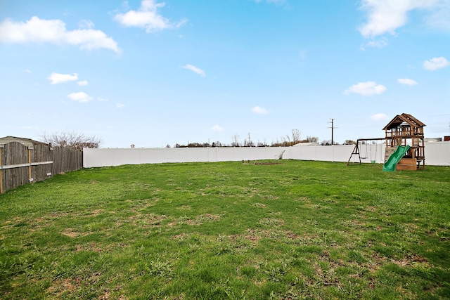 833 Poe St, Manteno, IL 60950 - view of yard featuring a fenced backyard and a playground