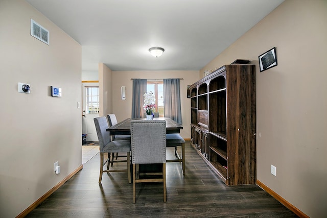 833 Poe St, Manteno, IL 60950 - dining area with baseboards, visible vents, and dark wood-type flooring