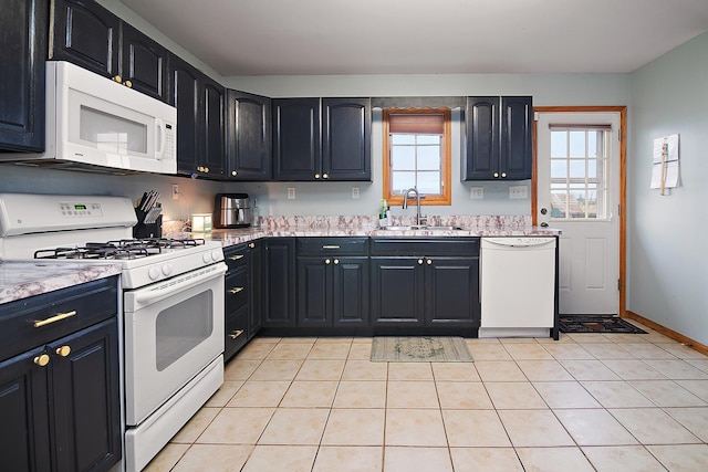 833 Poe St, Manteno, IL 60950 - kitchen featuring a wealth of natural light, a sink, white appliances, and light countertops
