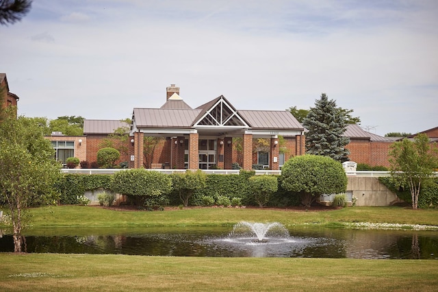 10300 Village Circle Dr Unit 1109, Palos Park, IL 60464 - back of property featuring a lawn, a water view, metal roof, brick siding, and a standing seam roof