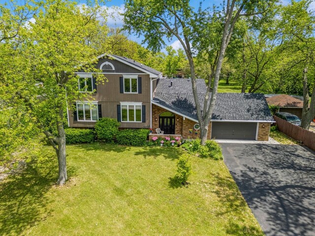5873 Walnut Ave, Downers Grove, IL 60516 - traditional-style home featuring asphalt driveway, a garage, brick siding, and roof with shingles
