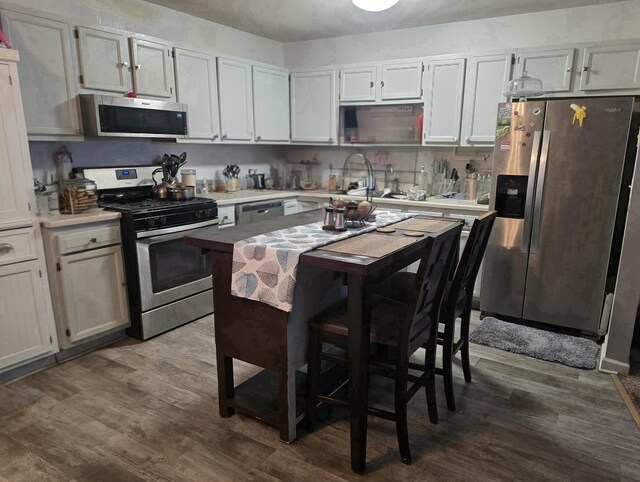 519 Greenwood Dr, Round Lake Park, IL 60073 - kitchen with stainless steel appliances, dark wood-style floors, and light countertops