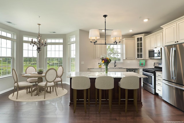 2701 Commons Dr Unit 409, Glenview, IL 60026 - kitchen featuring stainless steel appliances, a chandelier, healthy amount of natural light, and recessed lighting