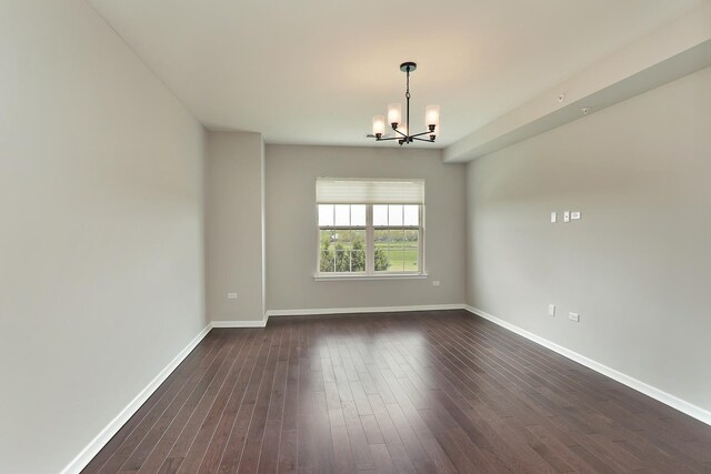 2701 Commons Dr Unit 409, Glenview, IL 60026 - spare room with a chandelier, dark wood-style floors, and baseboards