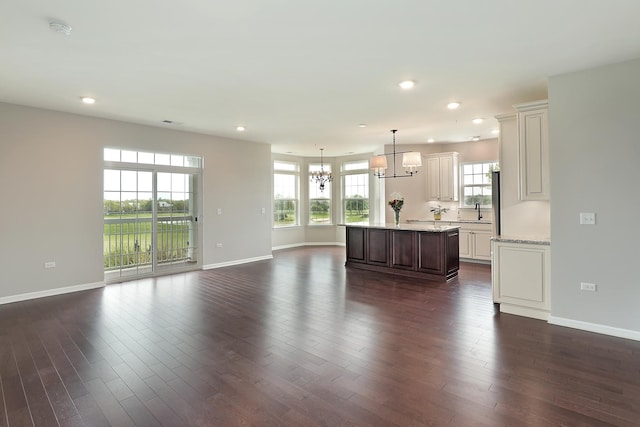 2701 Commons Dr Unit 409, Glenview, IL 60026 - unfurnished living room featuring a chandelier, recessed lighting, plenty of natural light, and baseboards