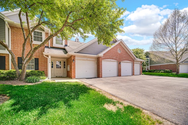 329 Pembroke Ct Unit 5, Schaumburg, IL 60193 - traditional-style home featuring brick siding, driveway, a garage, and a front yard