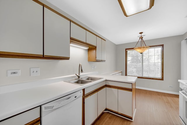 329 Pembroke Ct Unit 5, Schaumburg, IL 60193 - kitchen with white appliances, a sink, light countertops, light wood-style floors, and a peninsula