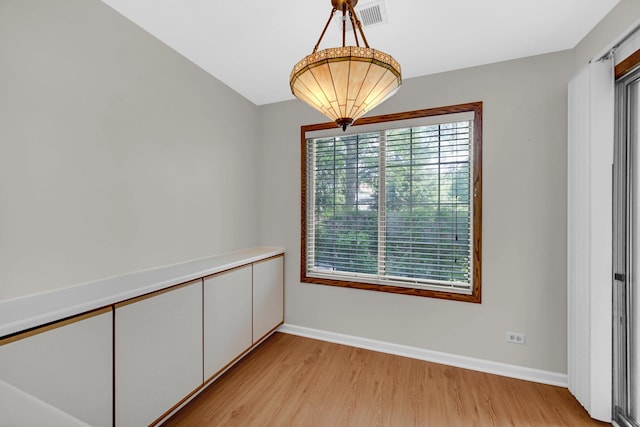 329 Pembroke Ct Unit 5, Schaumburg, IL 60193 - unfurnished dining area featuring light wood-type flooring and baseboards