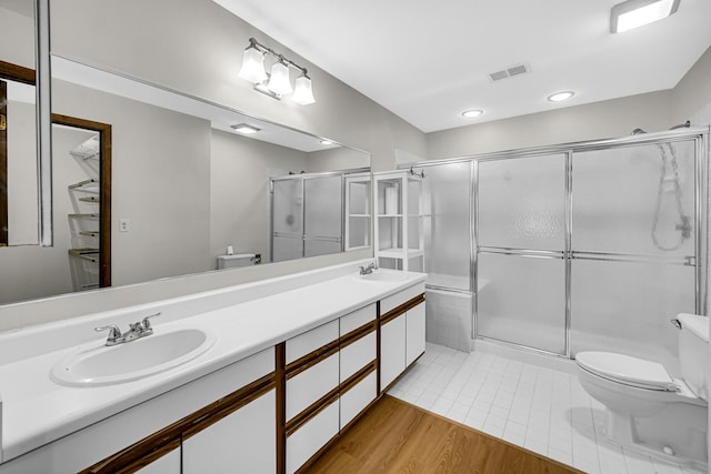 329 Pembroke Ct Unit 5, Schaumburg, IL 60193 - bathroom featuring toilet, a shower stall, double vanity, recessed lighting, and tile patterned floors