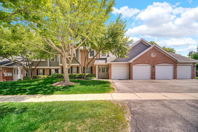 329 Pembroke Ct Unit 5, Schaumburg, IL 60193 - view of front of home with brick siding, driveway, a front yard, and an attached garage