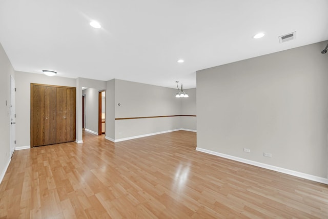329 Pembroke Ct Unit 5, Schaumburg, IL 60193 - unfurnished room with light wood finished floors, a chandelier, baseboards, and recessed lighting