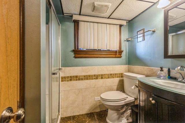 912 Macgregor Rd, Lockport, IL 60441 - bathroom featuring tile walls, a shower stall, vanity, toilet, and a wainscoted wall