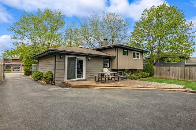 912 Macgregor Rd, Lockport, IL 60441 - back of property featuring fence, a wooden deck, a chimney, and a gate