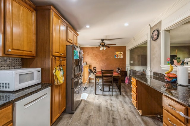 912 Macgregor Rd, Lockport, IL 60441 - kitchen with white appliances, brown cabinets, a ceiling fan, light wood-type flooring, and dark stone counters