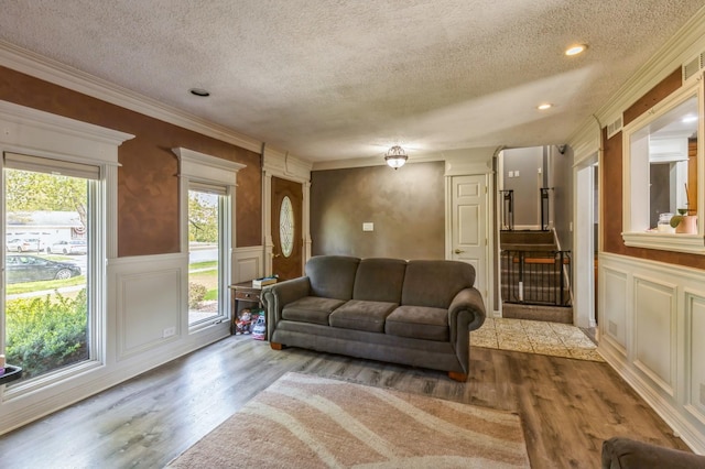 912 Macgregor Rd, Lockport, IL 60441 - living room with a textured ceiling, a decorative wall, wood finished floors, wainscoting, and crown molding