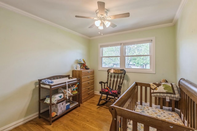 912 Macgregor Rd, Lockport, IL 60441 - bedroom featuring light wood-style flooring, a crib, baseboards, crown molding, and a ceiling fan