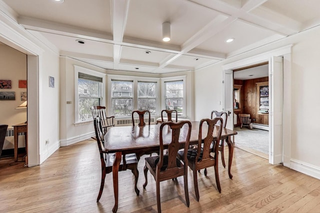 dining room featuring a baseboard heating unit, beam ceiling, light wood-type flooring, baseboards, and coffered ceiling