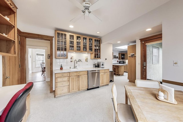 kitchen with dishwasher, backsplash, a sink, and recessed lighting