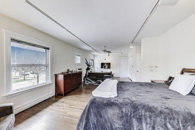bedroom featuring a ceiling fan and wood finished floors