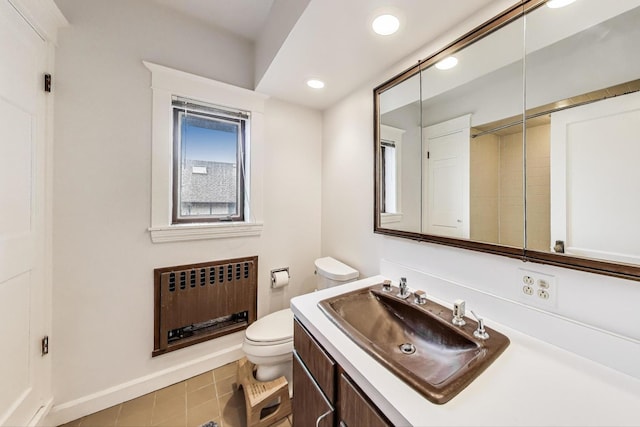 bathroom featuring toilet, radiator, baseboards, recessed lighting, and vanity