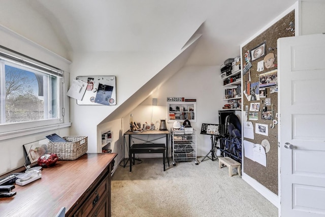 office with lofted ceiling and light colored carpet