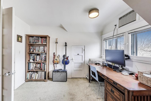 office area featuring an AC wall unit and light carpet