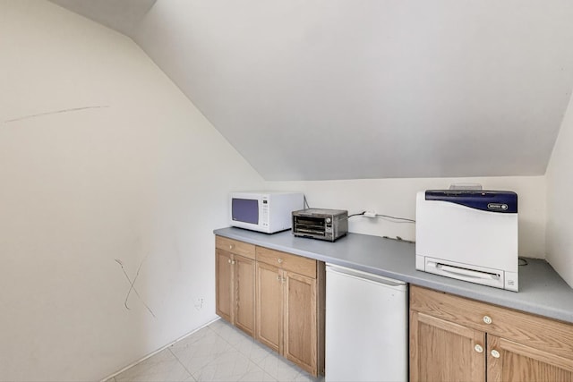 kitchen with lofted ceiling, a toaster, white microwave, and fridge