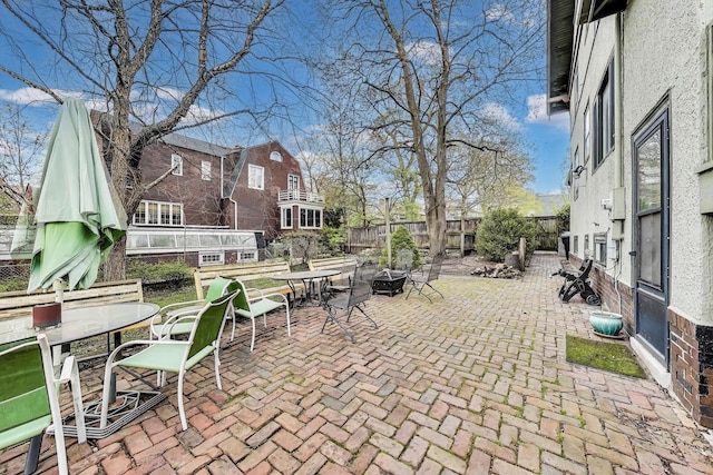 view of patio / terrace featuring outdoor dining space, an outdoor fire pit, and fence
