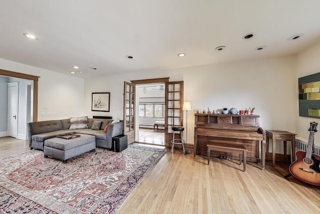 living room with hardwood / wood-style flooring, baseboards, and recessed lighting