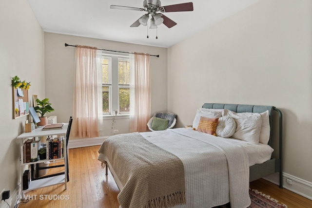 bedroom with baseboards, a ceiling fan, and hardwood / wood-style floors