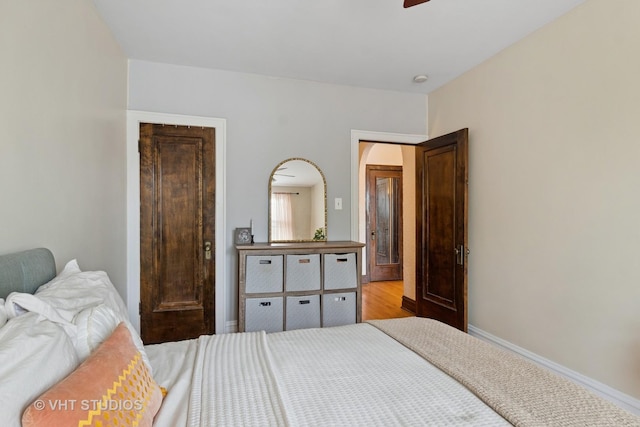 bedroom featuring baseboards and light wood-type flooring