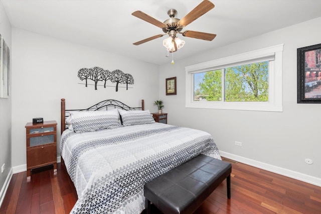 bedroom featuring baseboards, a ceiling fan, and hardwood / wood-style flooring