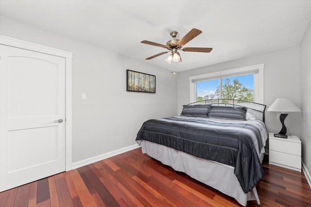 bedroom with baseboards, ceiling fan, and wood finished floors