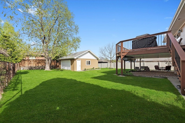 view of yard featuring a deck, an outbuilding, a fenced backyard, and a garage