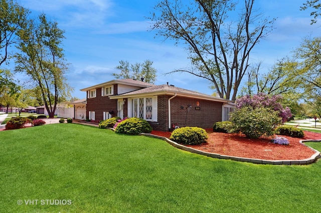 9125 W 144th Pl, Orland Park, IL 60462 - view of front facade with a garage, brick siding, and a front yard
