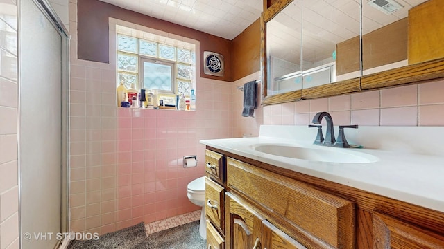 9125 W 144th Pl, Orland Park, IL 60462 - bathroom with tile walls, vanity, toilet, and a shower with shower door