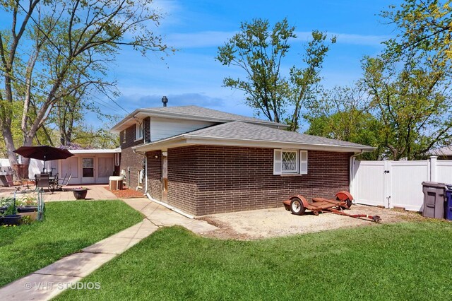 9125 W 144th Pl, Orland Park, IL 60462 - view of property exterior featuring brick siding, a gate, a patio area, and roof with shingles