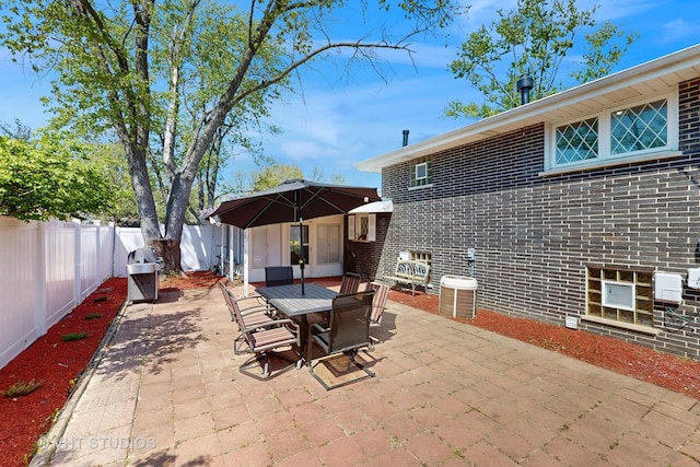 9125 W 144th Pl, Orland Park, IL 60462 - view of patio / terrace with a fenced backyard, outdoor dining area, and central AC unit
