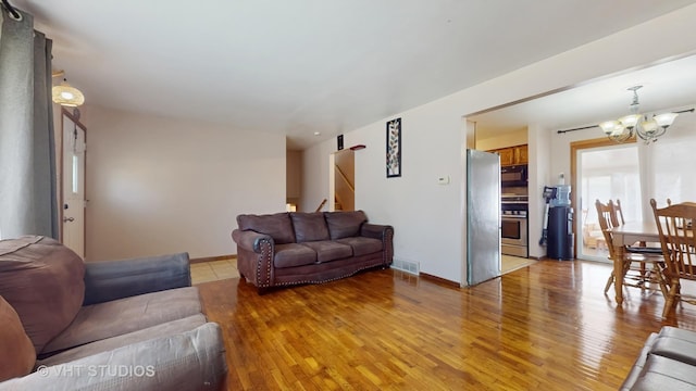 9125 W 144th Pl, Orland Park, IL 60462 - living area featuring a chandelier, light wood-style flooring, stairway, and baseboards