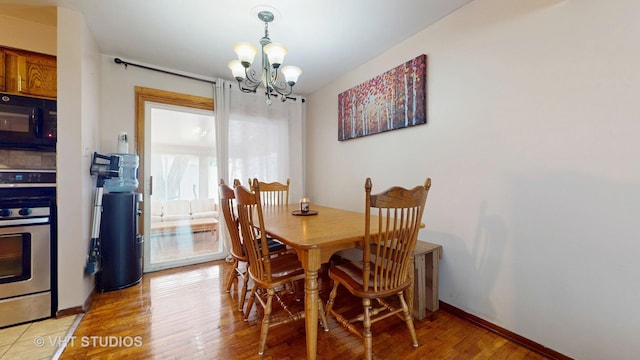 9125 W 144th Pl, Orland Park, IL 60462 - dining area featuring a chandelier, light wood-style flooring, and baseboards