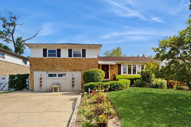 270 Concord Dr, Melrose Park, IL 60160 - tri-level home featuring a front lawn and brick siding