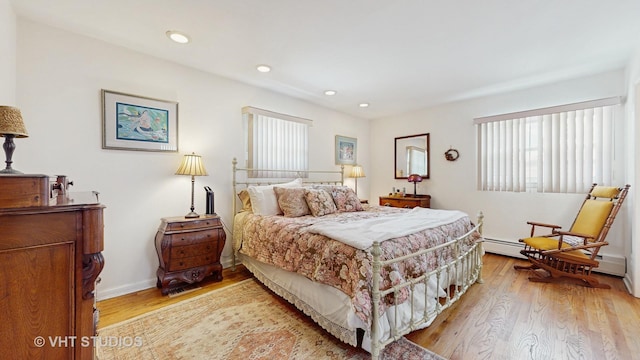 270 Concord Dr, Melrose Park, IL 60160 - bedroom with multiple windows, light wood-type flooring, a baseboard radiator, and recessed lighting