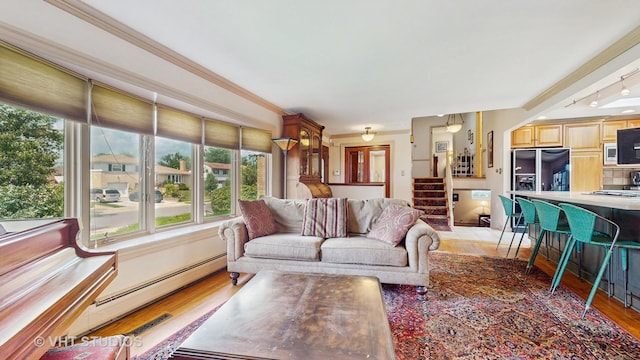 270 Concord Dr, Melrose Park, IL 60160 - living area featuring healthy amount of natural light, a baseboard heating unit, stairs, crown molding, and light wood-style flooring