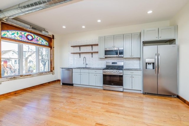 2625 W Cullerton St, Chicago, IL 60608 - kitchen featuring tasteful backsplash, open shelves, a sink, stainless steel appliances, and baseboards