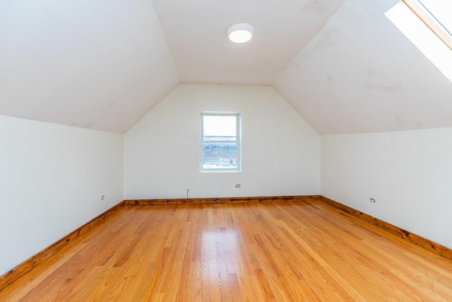 2625 W Cullerton St, Chicago, IL 60608 - bonus room featuring baseboards, lofted ceiling with skylight, and light wood finished floors
