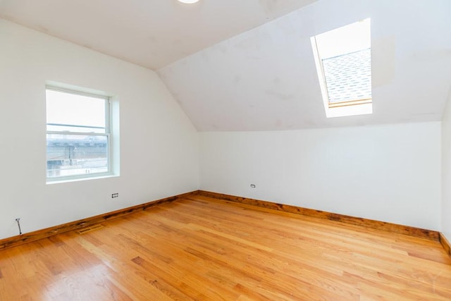 2625 W Cullerton St, Chicago, IL 60608 - bonus room featuring light wood-style flooring, baseboards, and lofted ceiling with skylight