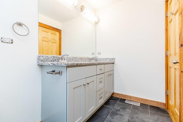 2625 W Cullerton St, Chicago, IL 60608 - bathroom with visible vents, baseboards, a sink, and double vanity