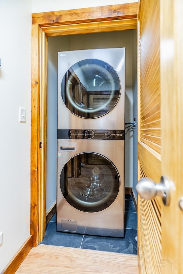 2625 W Cullerton St, Chicago, IL 60608 - laundry room featuring stacked washer / drying machine, tile patterned floors, baseboards, and laundry area